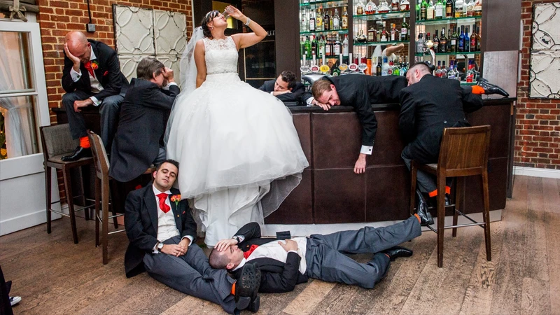End of the night after a fantastic wedding reception with the Bride having drunk the Groom and Best men undr the table!
